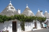 The Trulli, limestone dwellings of Rione Monti, Alberbello.  Some have mythological or religious symbols in white ash on the rooves.
