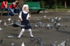 Children chasing pigeons outside Zenkov Cathedral, Almaty KZ