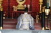 Monk praying in the honden, or main shrine at Dazaifu, Japan