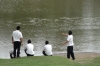 School boys throwing stomes into the moat at Kumamoto Castle, Japan