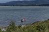 Fishing boat (collecting kelp?). Straits of Magellan Park CL
