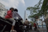 Girl on scooter and the new BiTexco Financial Tower, Saigon VN