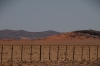 Red dunes encroaching on the rocky land, C14 north of Solitaire, Namibia